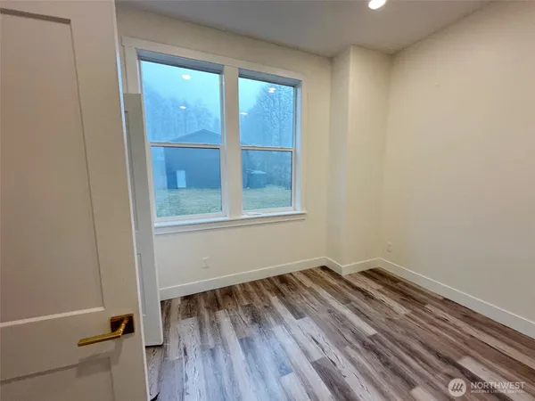 a large kitchen with kitchen island a stove a sink dishwasher and a refrigerator with wooden floor