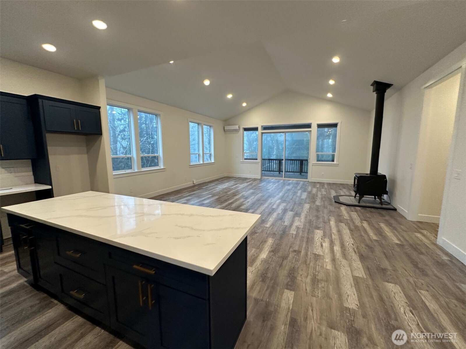 559 Upper Naselle Road Naselle, WA 98638 - Photo 15 of 32 a large kitchen with kitchen island a stove a sink dishwasher and a refrigerator with wooden floor