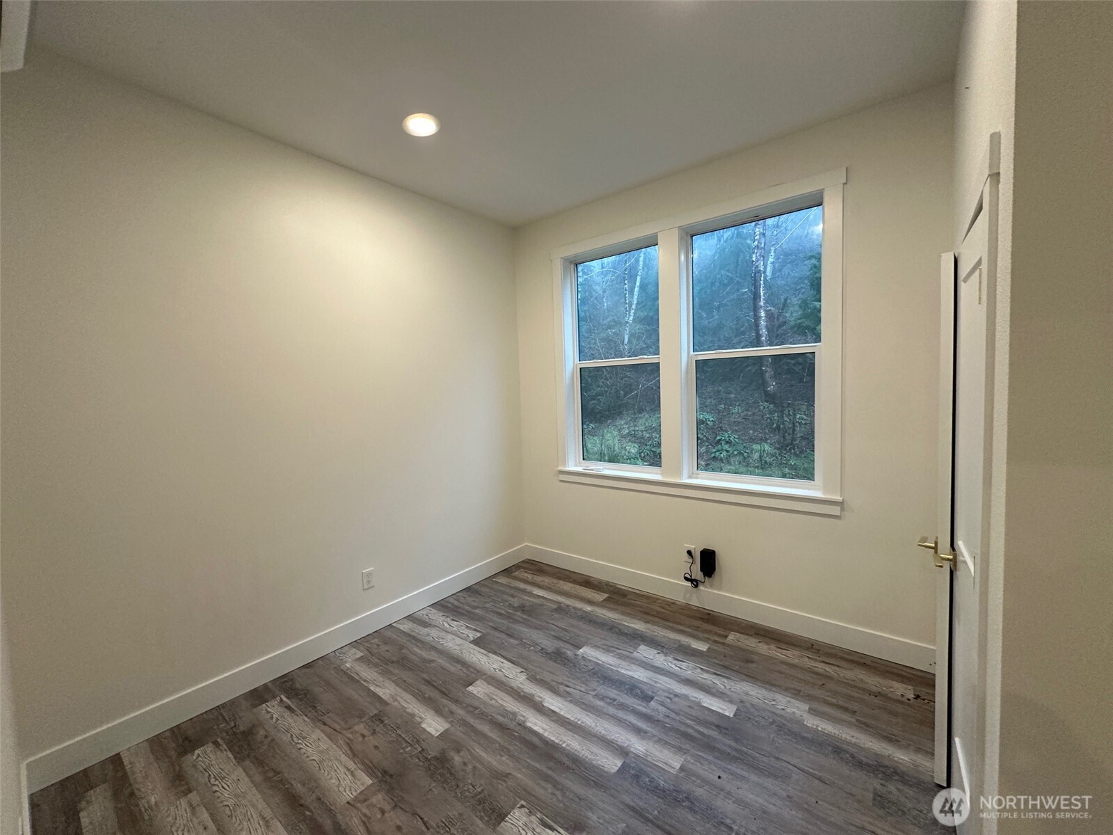 559 Upper Naselle Road Naselle, WA 98638 - Photo 20 of 32 a view of empty room with wooden floor and fan