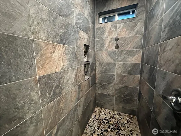a white toilet sitting next to a white sink and vanity