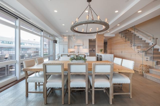 a view of a dining room with furniture wooden floor and chandelier