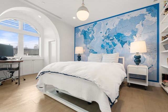 a bed room with a bed and a painting on the wall