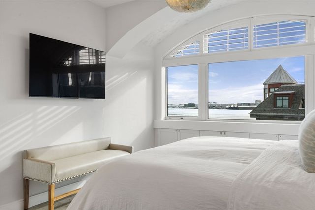 a bedroom with a bed and a television