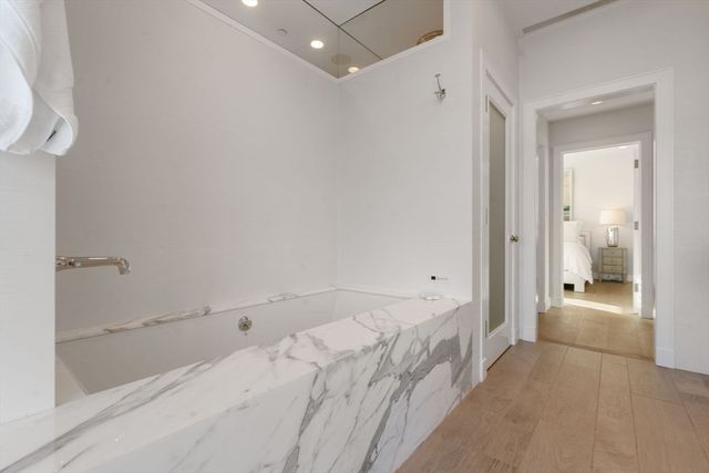 a bathroom with a bathtub and a shower