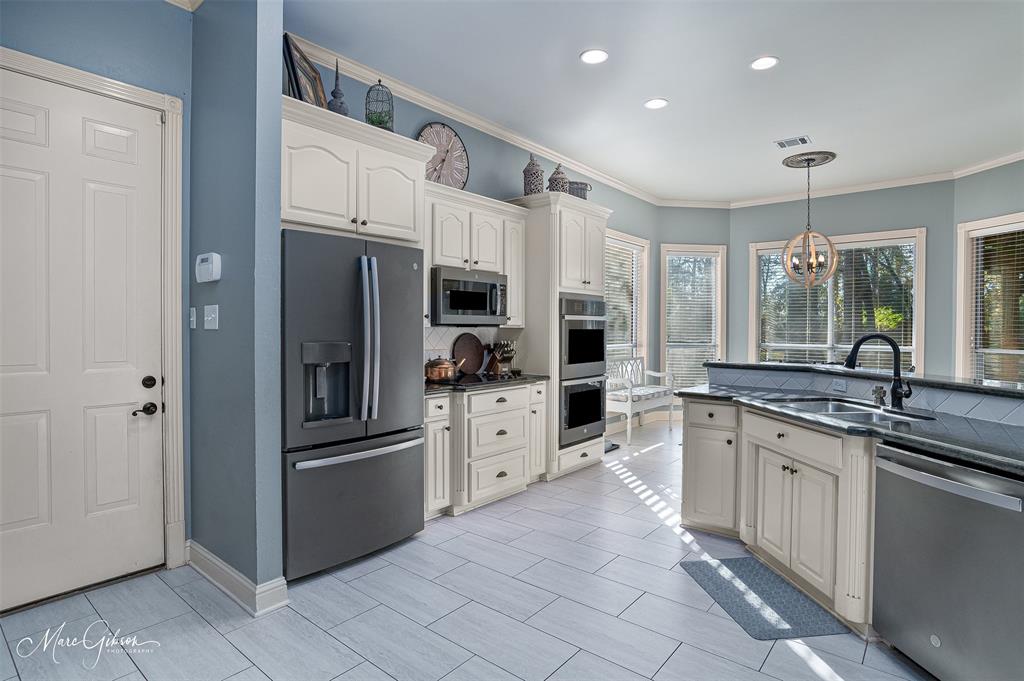 1310 Bay Ridge Drive Bossier City, LA 71111 - Photo 11 of 37 a kitchen with white cabinets and stainless steel appliances