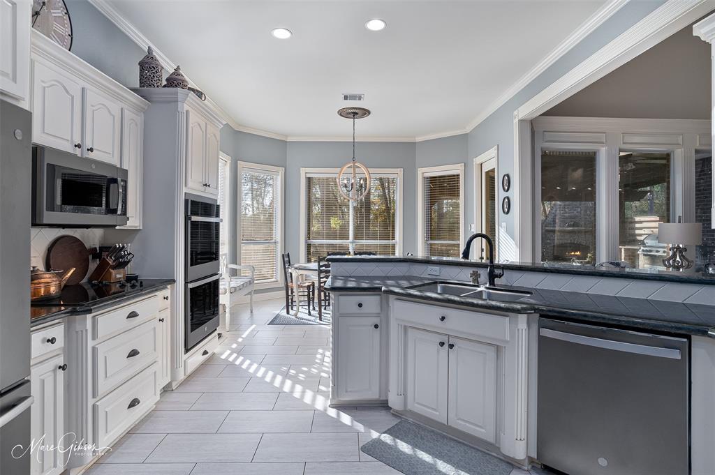 1310 Bay Ridge Drive Bossier City, LA 71111 - Photo 13 of 37 a kitchen with granite countertop a sink and cabinets