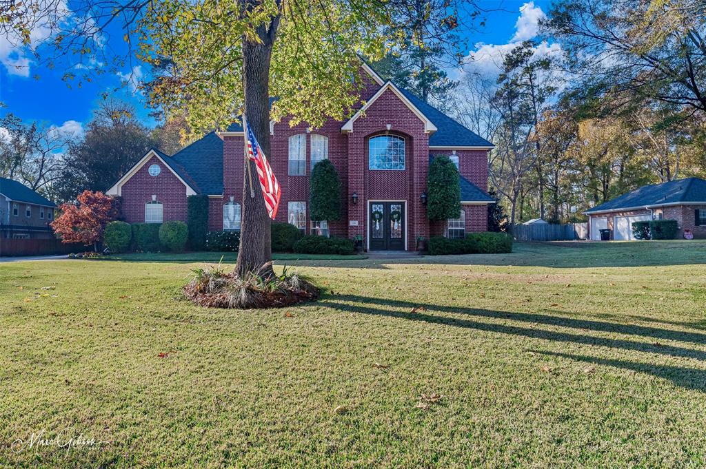 1310 Bay Ridge Drive Bossier City, LA 71111 - Photo 2 of 37 a front view of a house with a yard