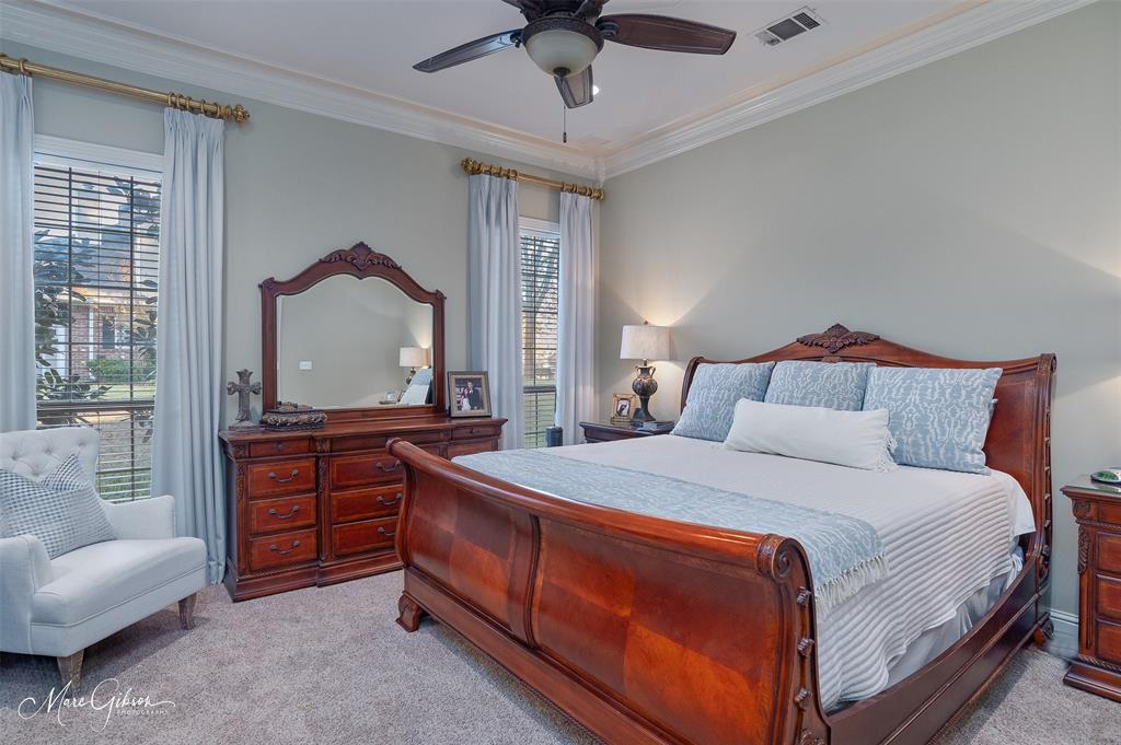1310 Bay Ridge Drive Bossier City, LA 71111 - Photo 21 of 37 a bedroom with a bed a chandelier and a dresser