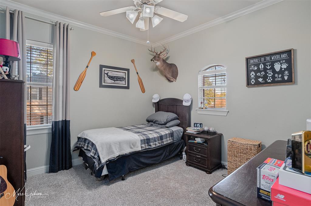 1310 Bay Ridge Drive Bossier City, LA 71111 - Photo 30 of 37 a bedroom with a bed and a chandelier