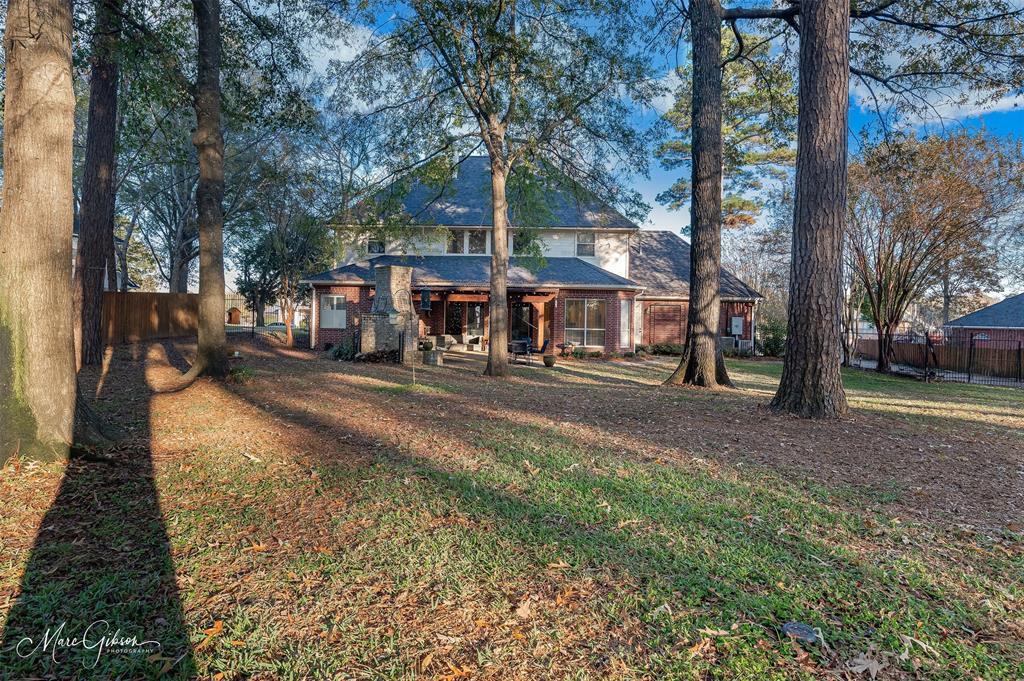 1310 Bay Ridge Drive Bossier City, LA 71111 - Photo 37 of 37 a front view of a house with a yard and large trees