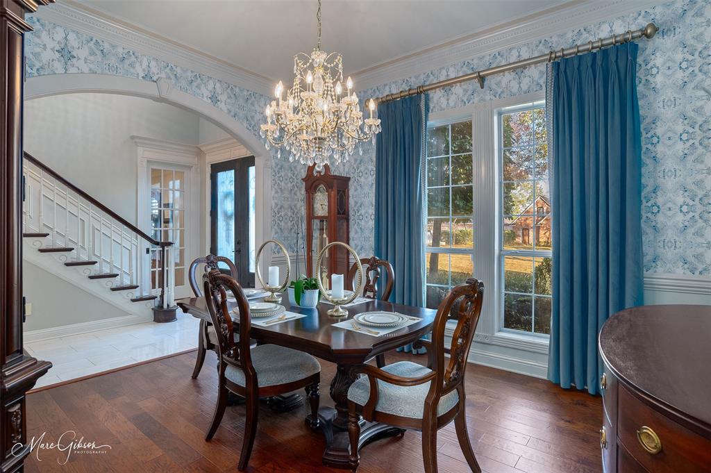 1310 Bay Ridge Drive Bossier City, LA 71111 - Photo 10 of 37 a view of a dining room with furniture a chandelier and wooden floor