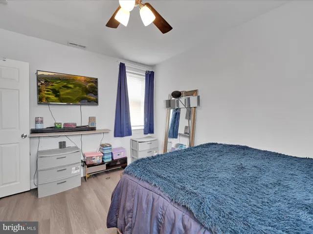 a bedroom with furniture and a flat screen tv