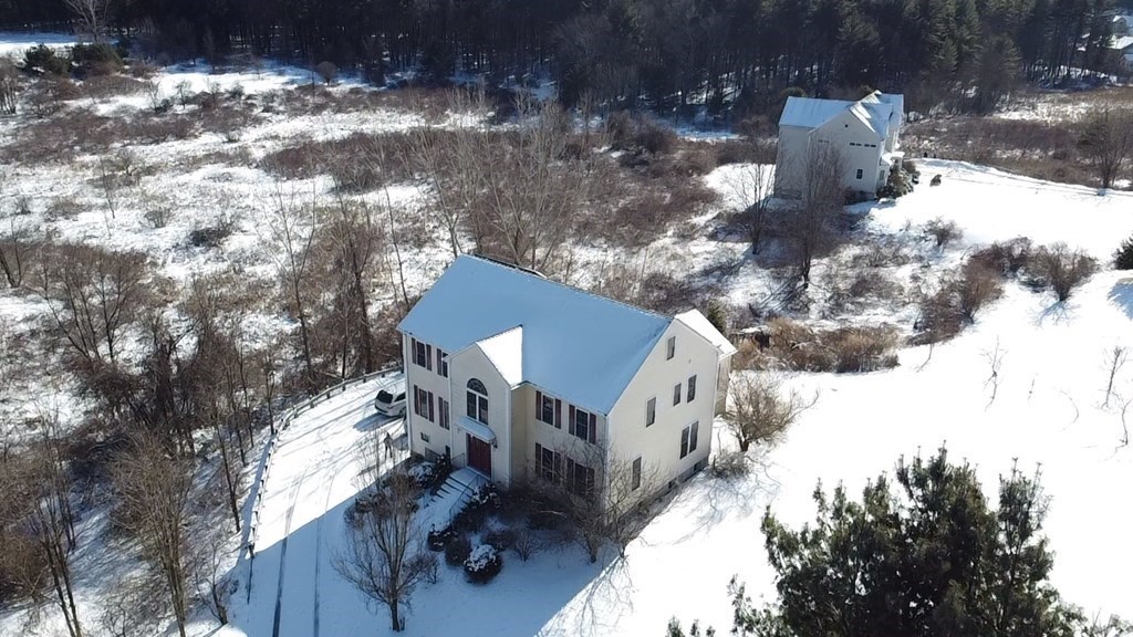 218 Littleton County Road Harvard, MA 01451 - Photo 1 of 41 a view of a house with a yard covered in snow