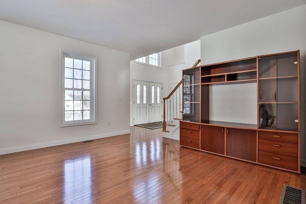 218 Littleton County Road Harvard, MA 01451 - Photo 22 of 41 a living room with wooden floors and a chair