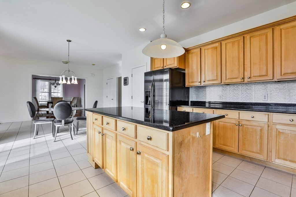 218 Littleton County Road Harvard, MA 01451 - Photo 7 of 41 a kitchen with stainless steel appliances granite countertop a sink and a refrigerator