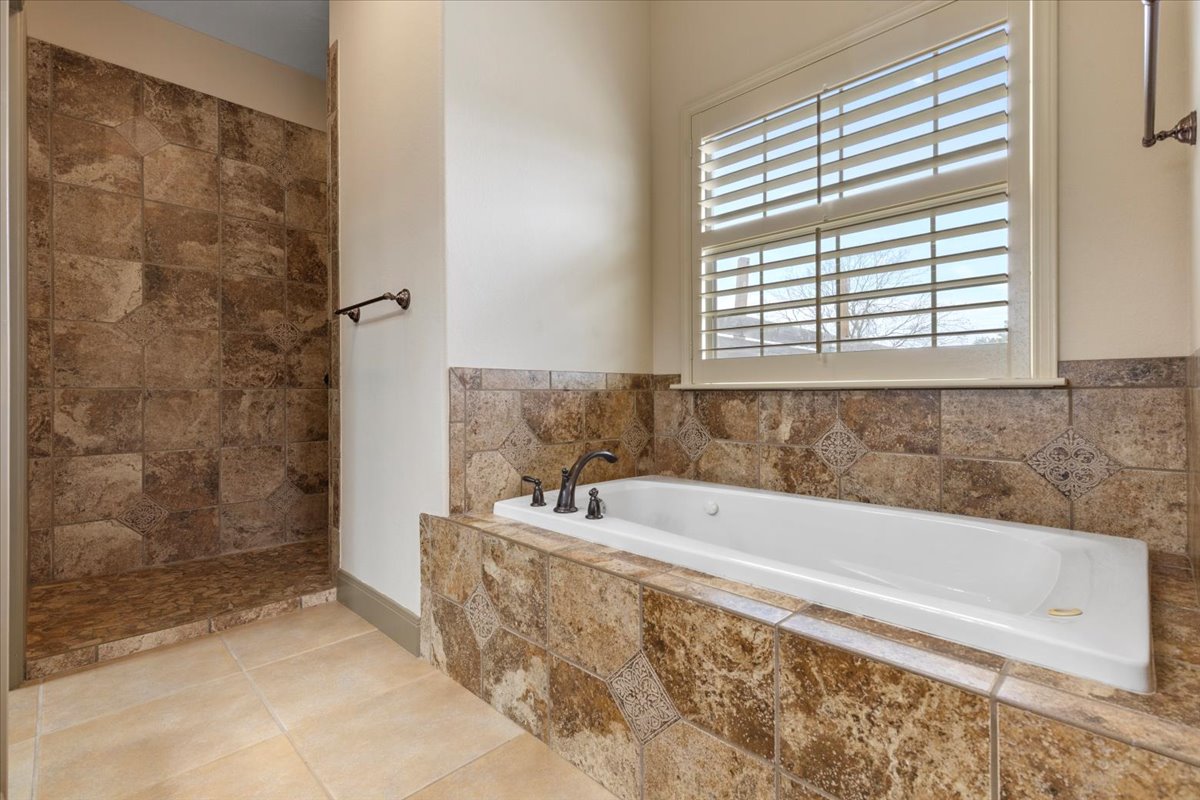 106 Spring Meadow Road Bastrop, TX 78602 - Photo 20 of 39 Bathroom with a bath, tile patterned floors, and walk in shower