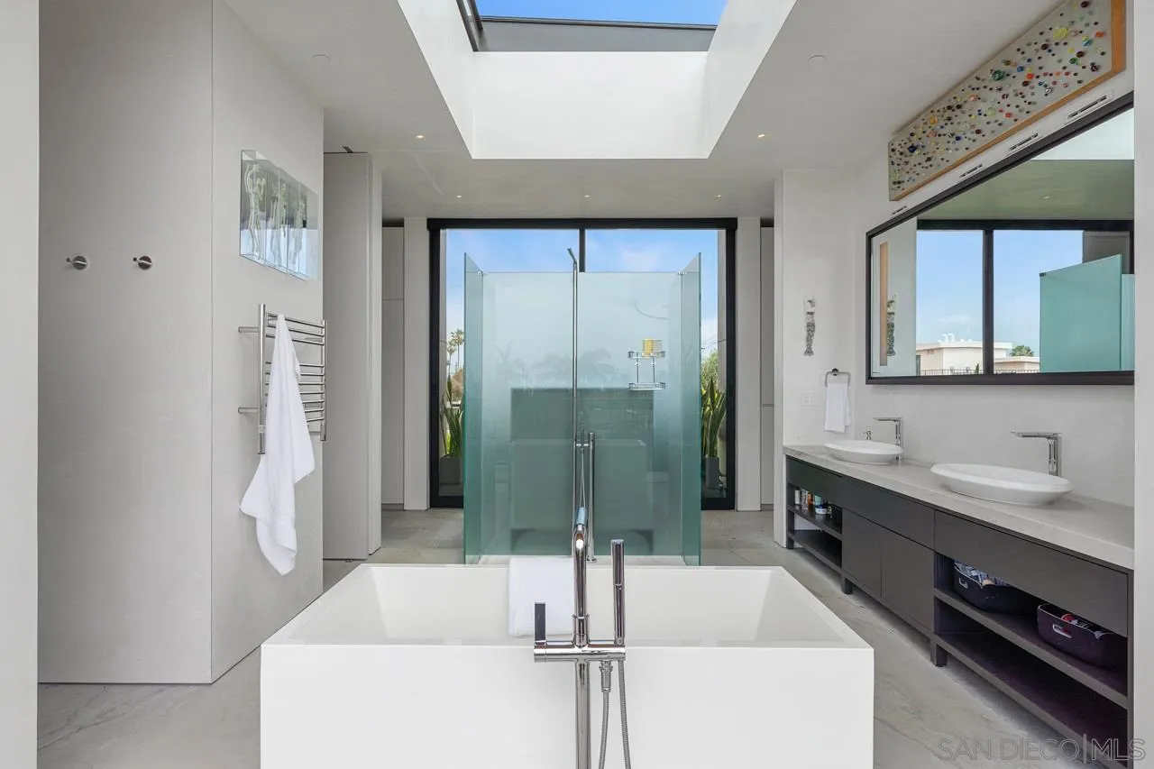 1228 Park Row La Jolla, CA 92037 - Photo 22 of 35 a bathroom with a tub a sink and mirrors