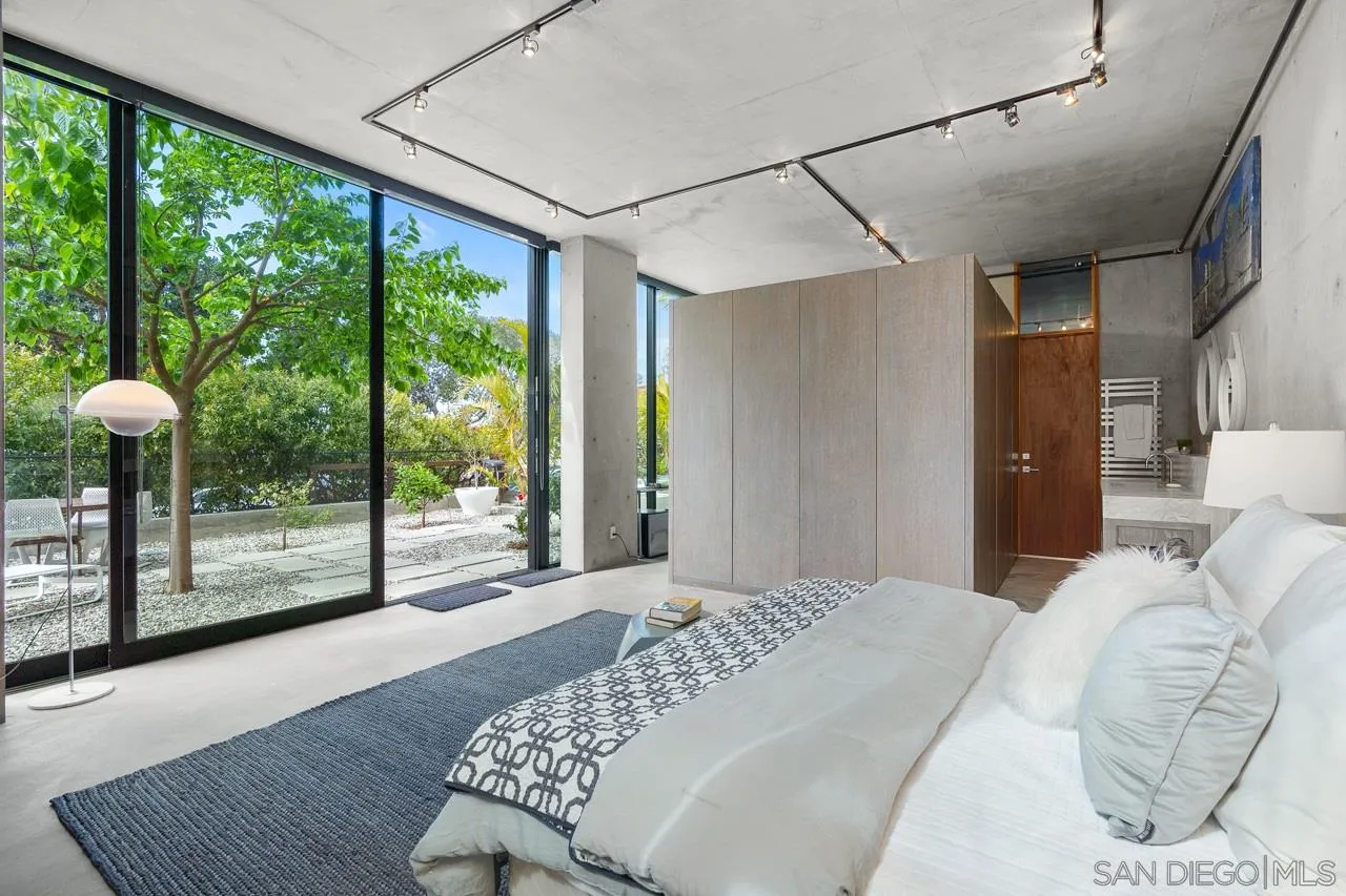 1228 Park Row La Jolla, CA 92037 - Photo 24 of 35 a bedroom with a bed and glass window