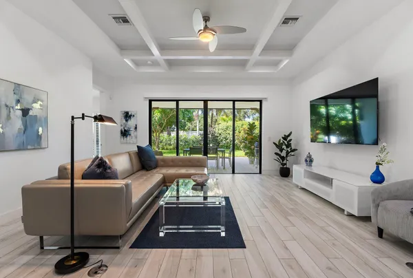 a living room with furniture and a wooden floor