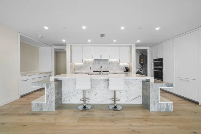 a view of kitchen with stainless steel appliances cabinets and wooden floor