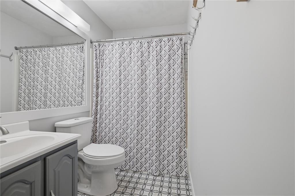 580 Maple Court Hidden Valley, PA 15502 - Photo 18 of 28 a bathroom with a toilet and a shower curtain
