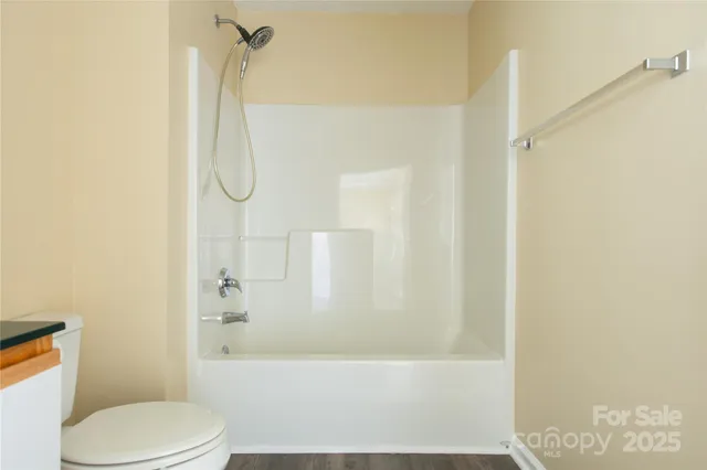 a bathroom with a toilet and shower