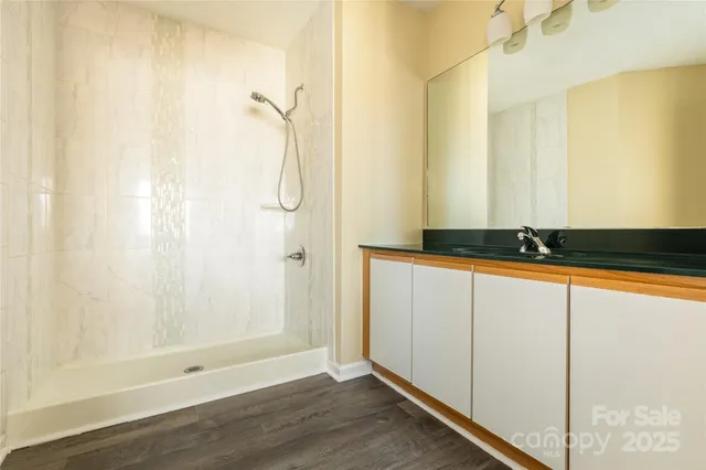 a bathroom with a shower and a mirror