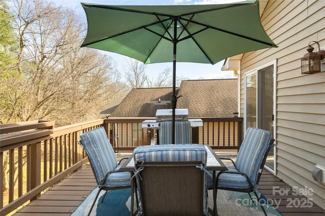 a view of balcony with furniture and umbrella
