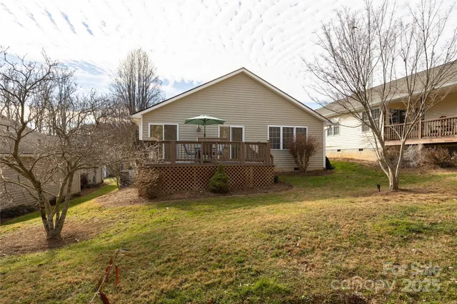 a view of a house with a yard covered in snow