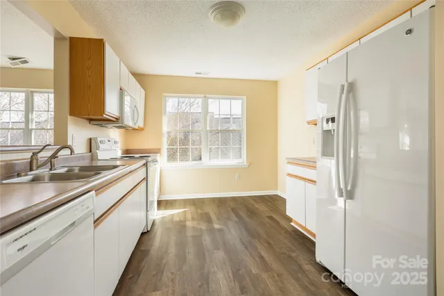 a view of a kitchen cabinets a sink and wooden floor