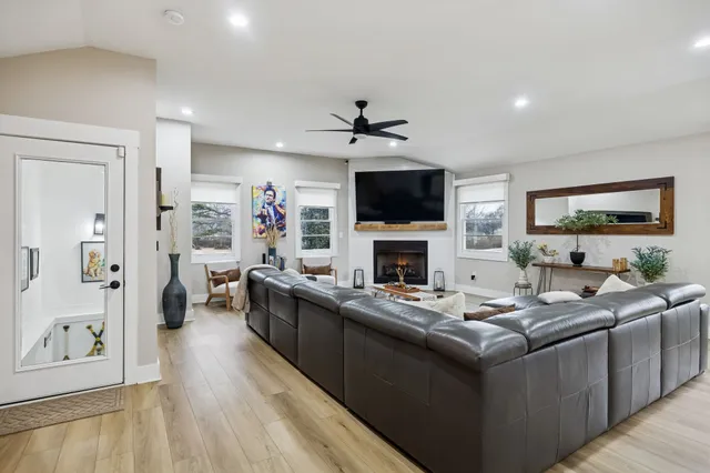 a living room with furniture a window and a table