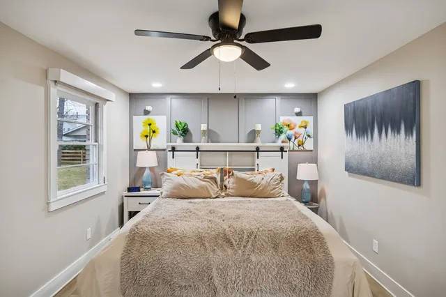 a bedroom with a large bed and a window