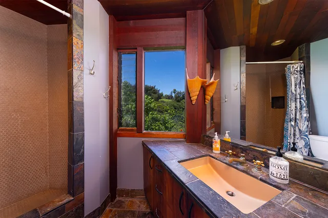 a bathroom with a granite countertop sink and a mirror