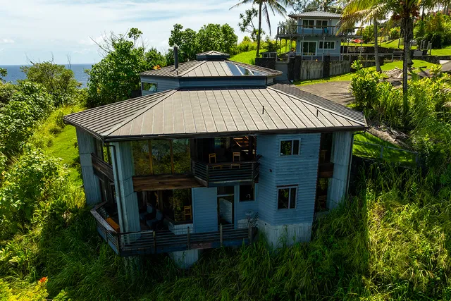 a view of a house with roof deck and garden