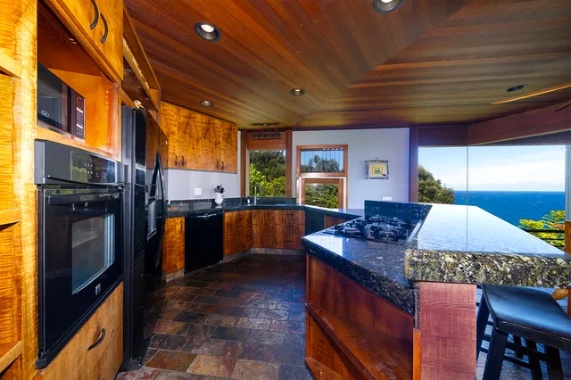 a kitchen with stainless steel appliances granite countertop a stove a sink dishwasher and granite countertops
