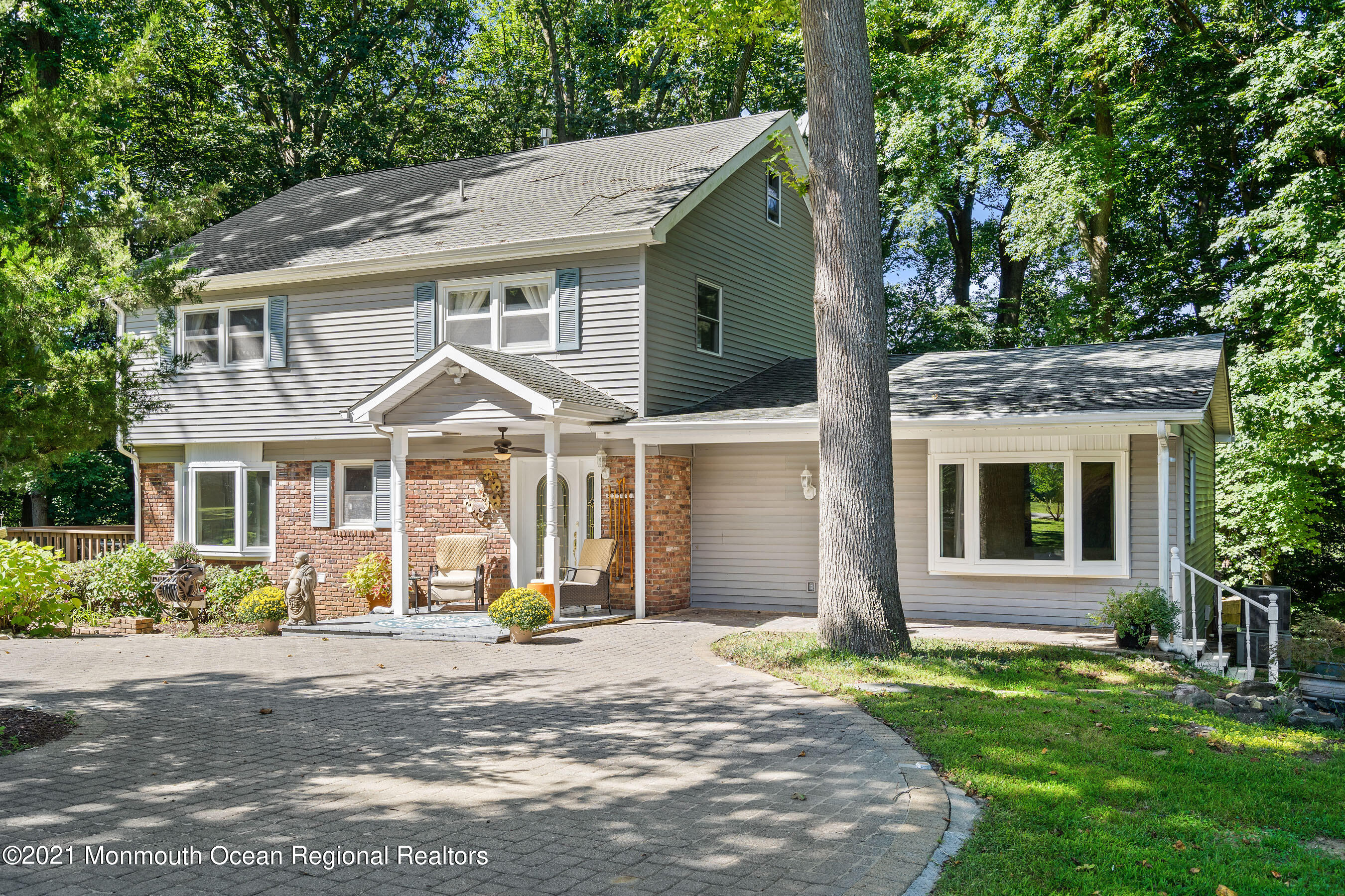 88 Beechwood Road Lincroft, NJ 07738 - Photo 1 of 33 a view of a white house with a big yard and large tree