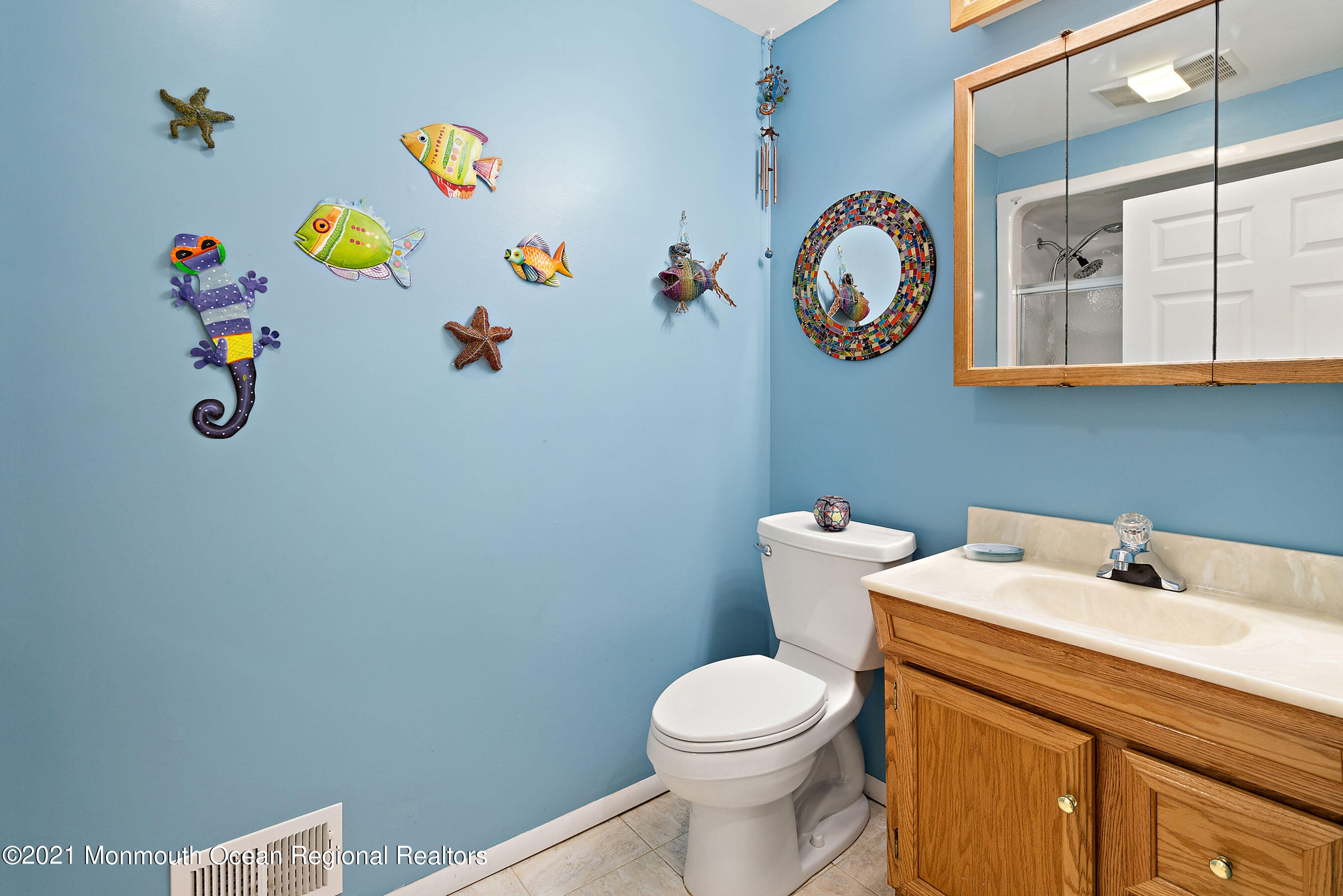 88 Beechwood Road Lincroft, NJ 07738 - Photo 18 of 33 a bathroom with a sink a mirror and toilet