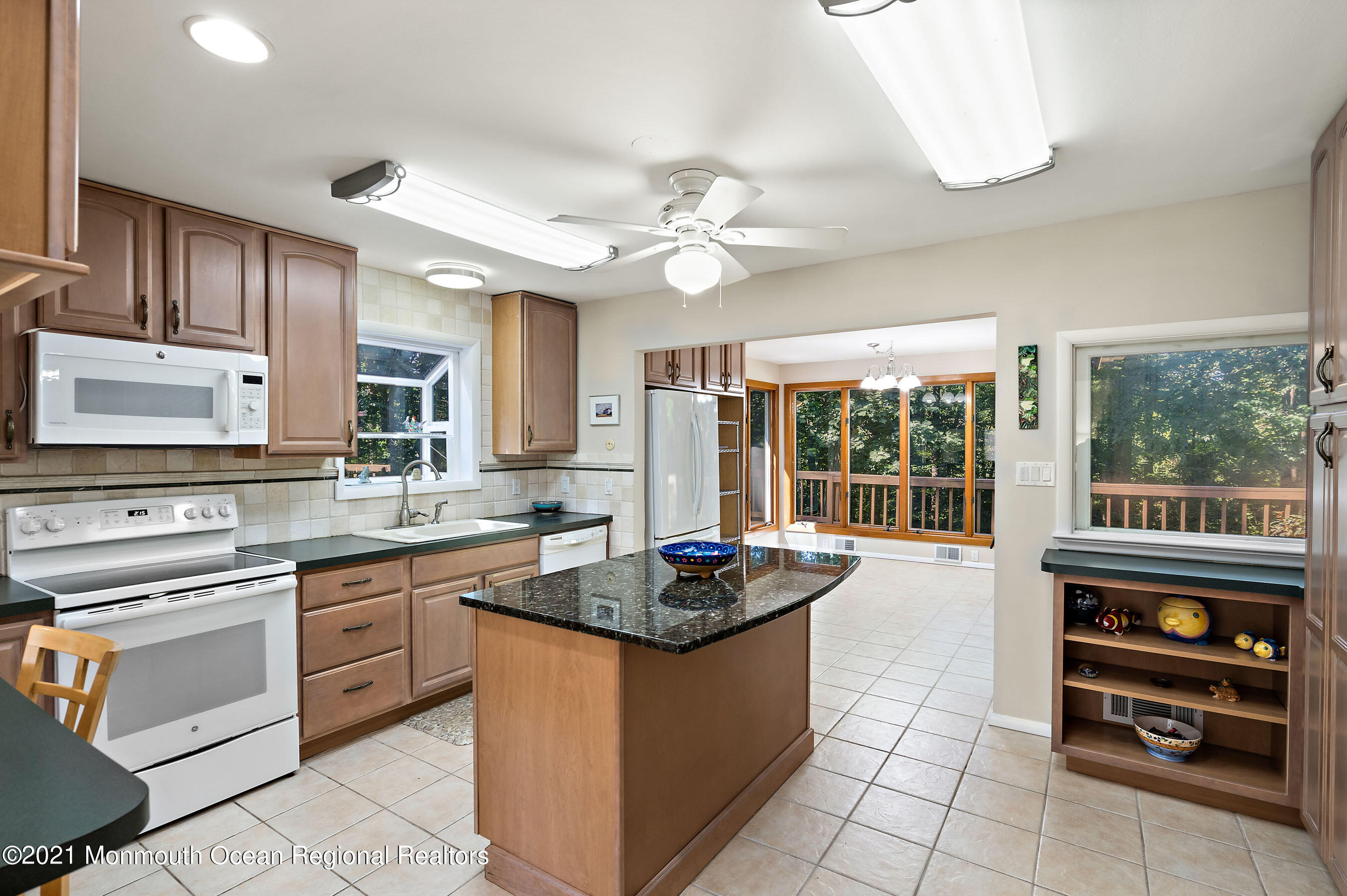 88 Beechwood Road Lincroft, NJ 07738 - Photo 8 of 33 a kitchen with stainless steel appliances granite countertop a stove a sink and a refrigerator