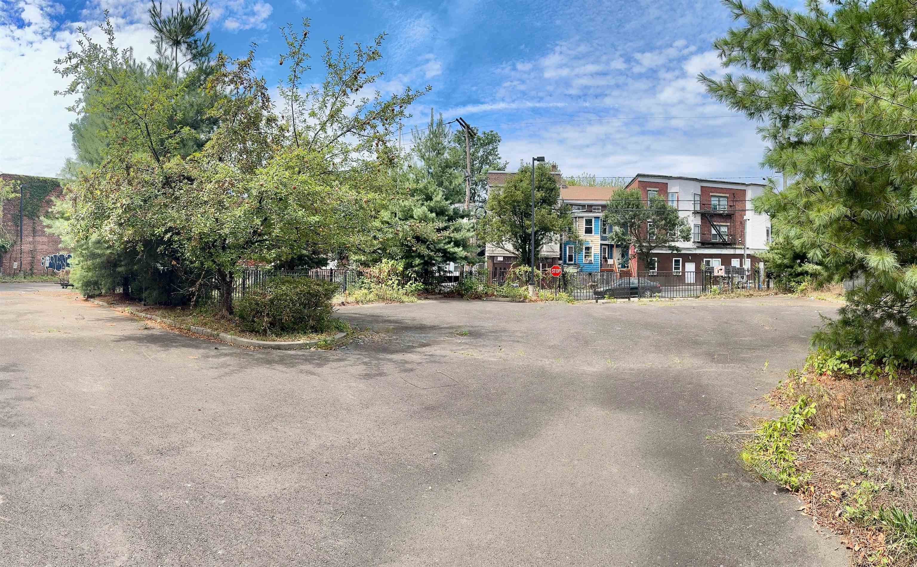 66-68 North Main Street Paterson, NJ 07522 - Photo 2 of 5 a view of street with a bench and trees