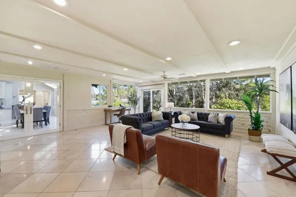 a living room with furniture and large windows