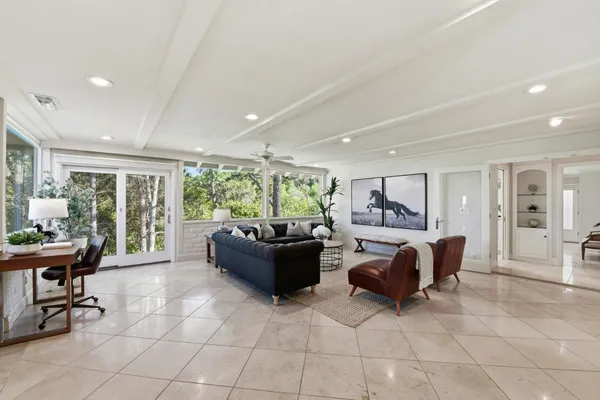 a living room with furniture and large windows
