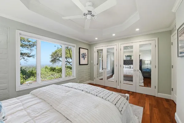 a spacious bedroom with a large bed and a large window