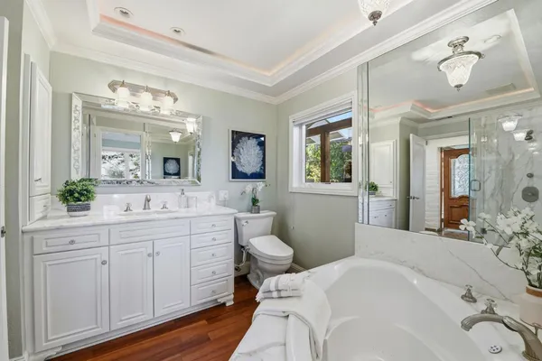 a spacious bathroom with a double vanity sink mirror and toilet