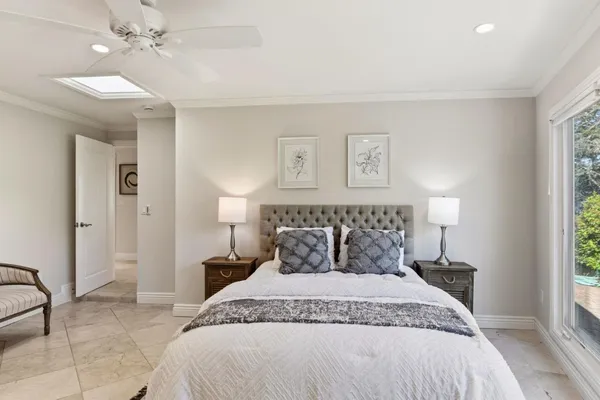 a bedroom with a large bed and a chandelier