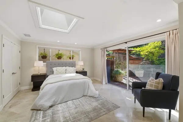 a bedroom with a bed and glass window
