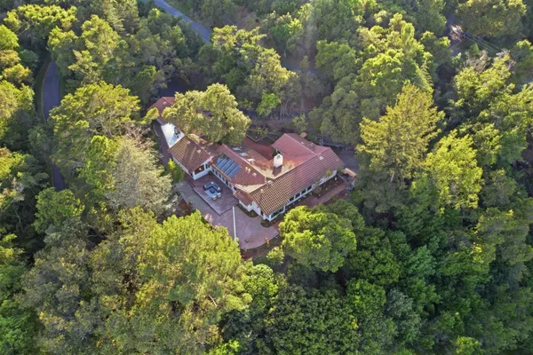 an aerial view of a house with a yard