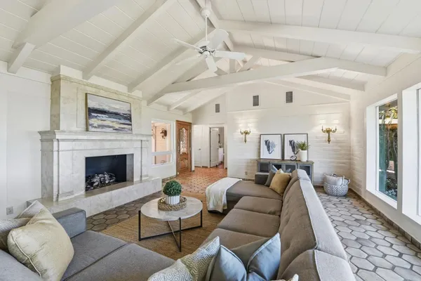 a living room with furniture a fireplace and a table
