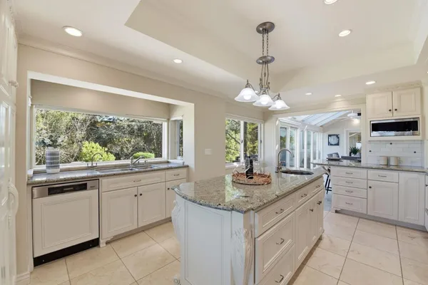 a kitchen with center island and windows
