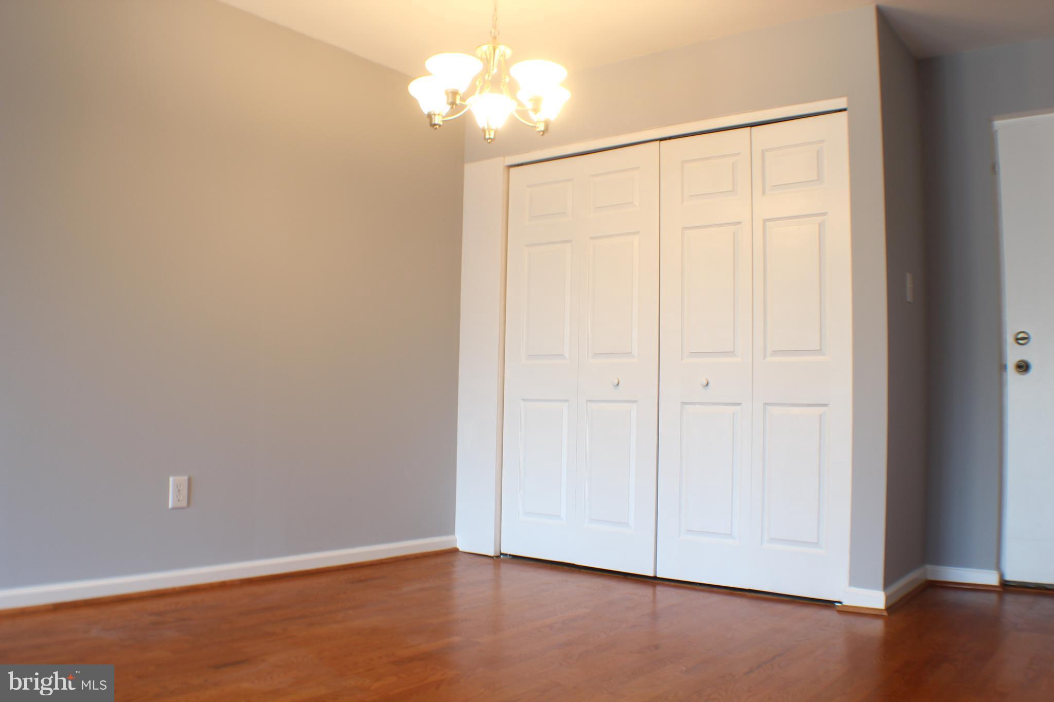 5816 Royal Ridge Drive, Unit D Springfield, VA 22152 - Photo 10 of 15 an empty room with wooden floor and closet