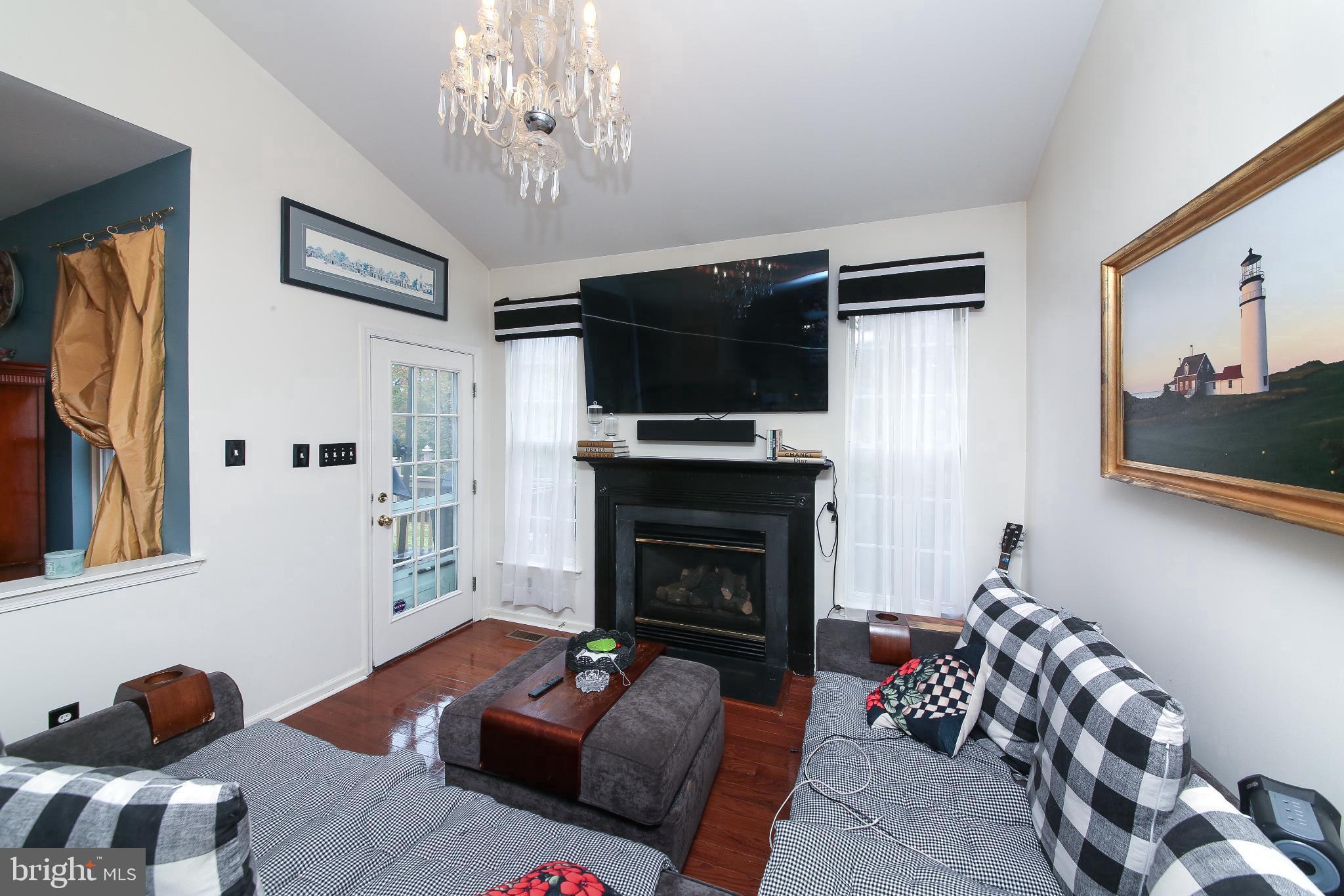 535 Mockingbird Way Warrington, PA 18976 - Photo 7 of 27 a living room with furniture a flat screen tv and a fireplace